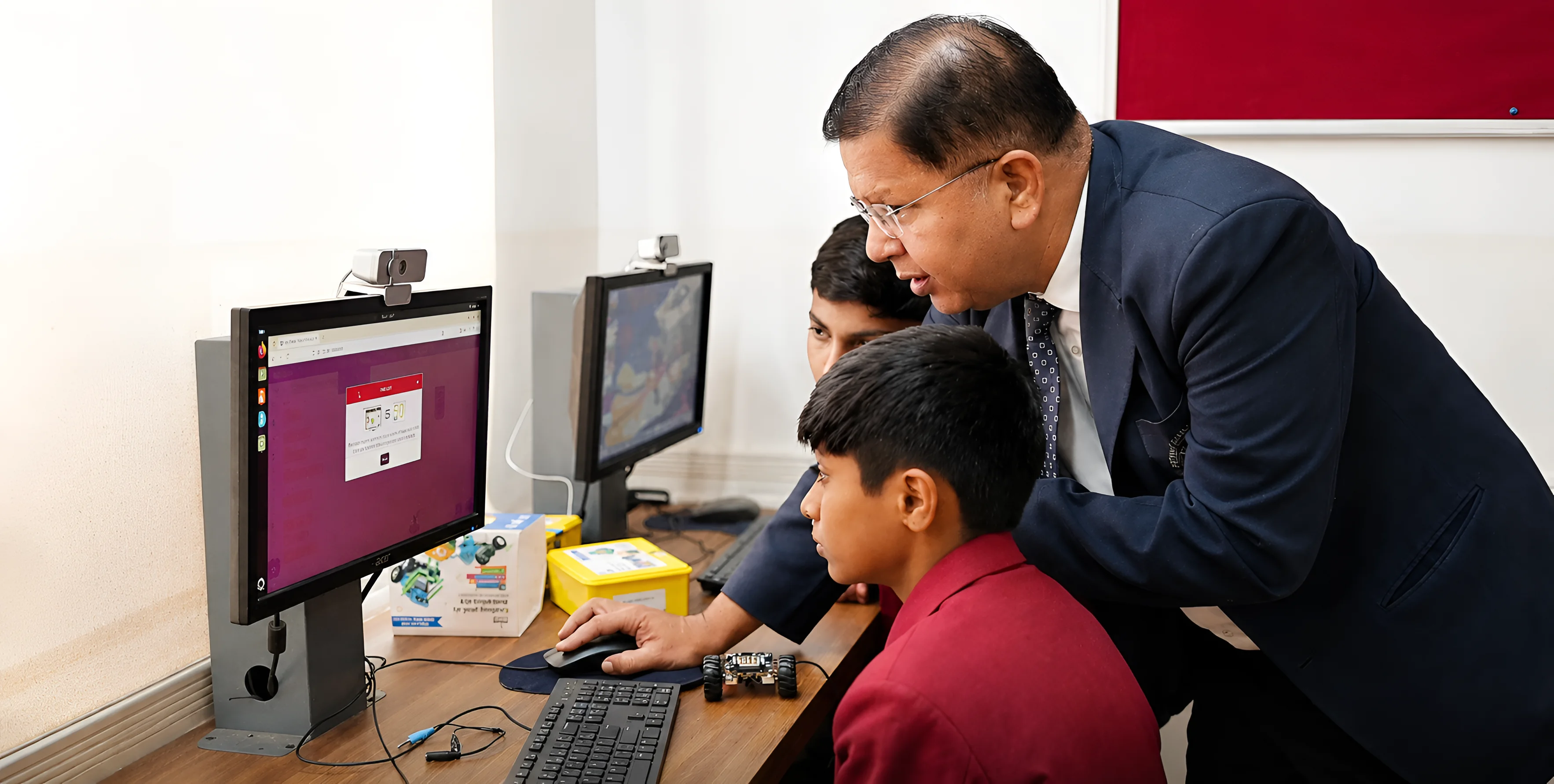 Teacher guiding students with technology